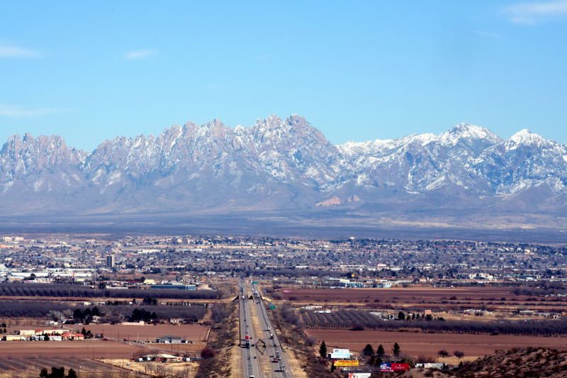 Las Cruces with the snow-dusted Organ Mountains rising behind the city.